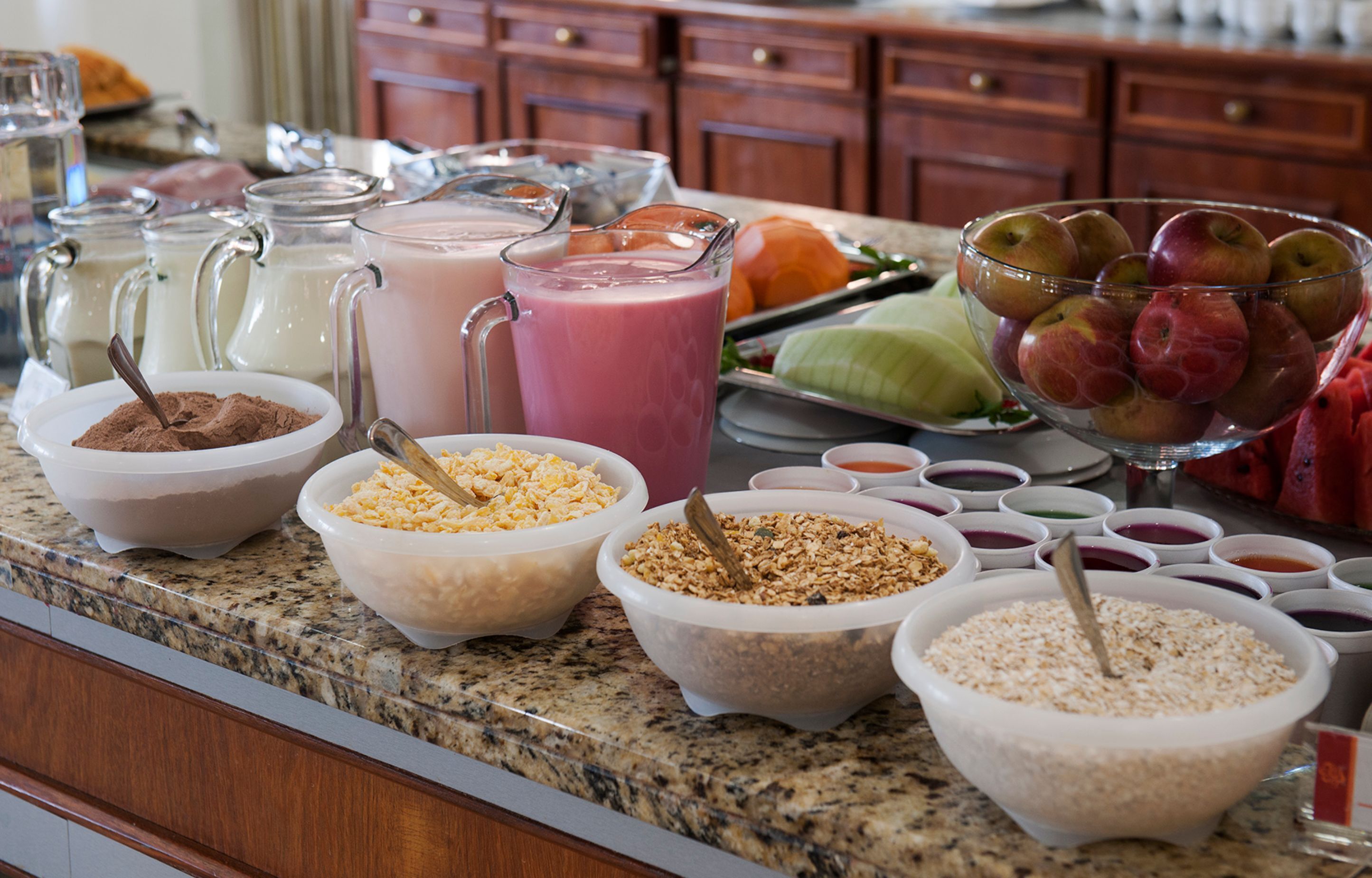 A buffet with various food items and beverages.