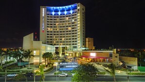 A multi-story hotel with a prominent sign for "PlazaKrystal Cancun Centro". - Krystal Urban Cancun & Beach Club (Cancun)