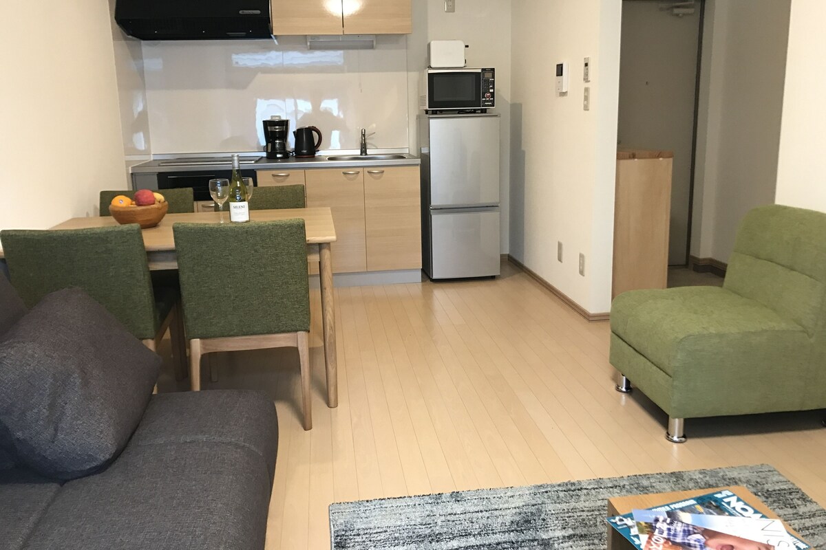 A compact living space with a kitchenette, a dining area, and a seating area.