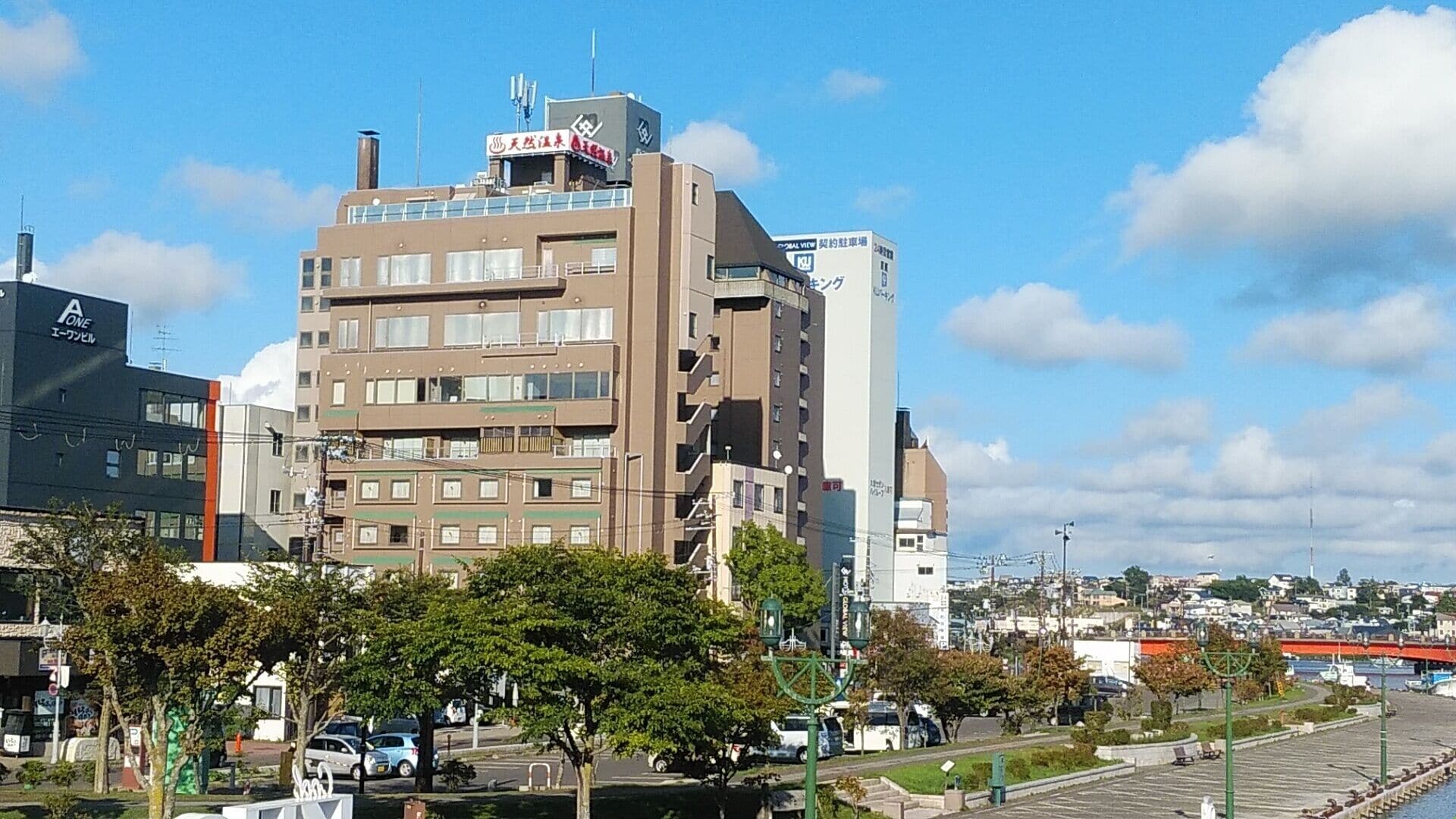 A multi-story building with a sign indicating a business on the top floor.