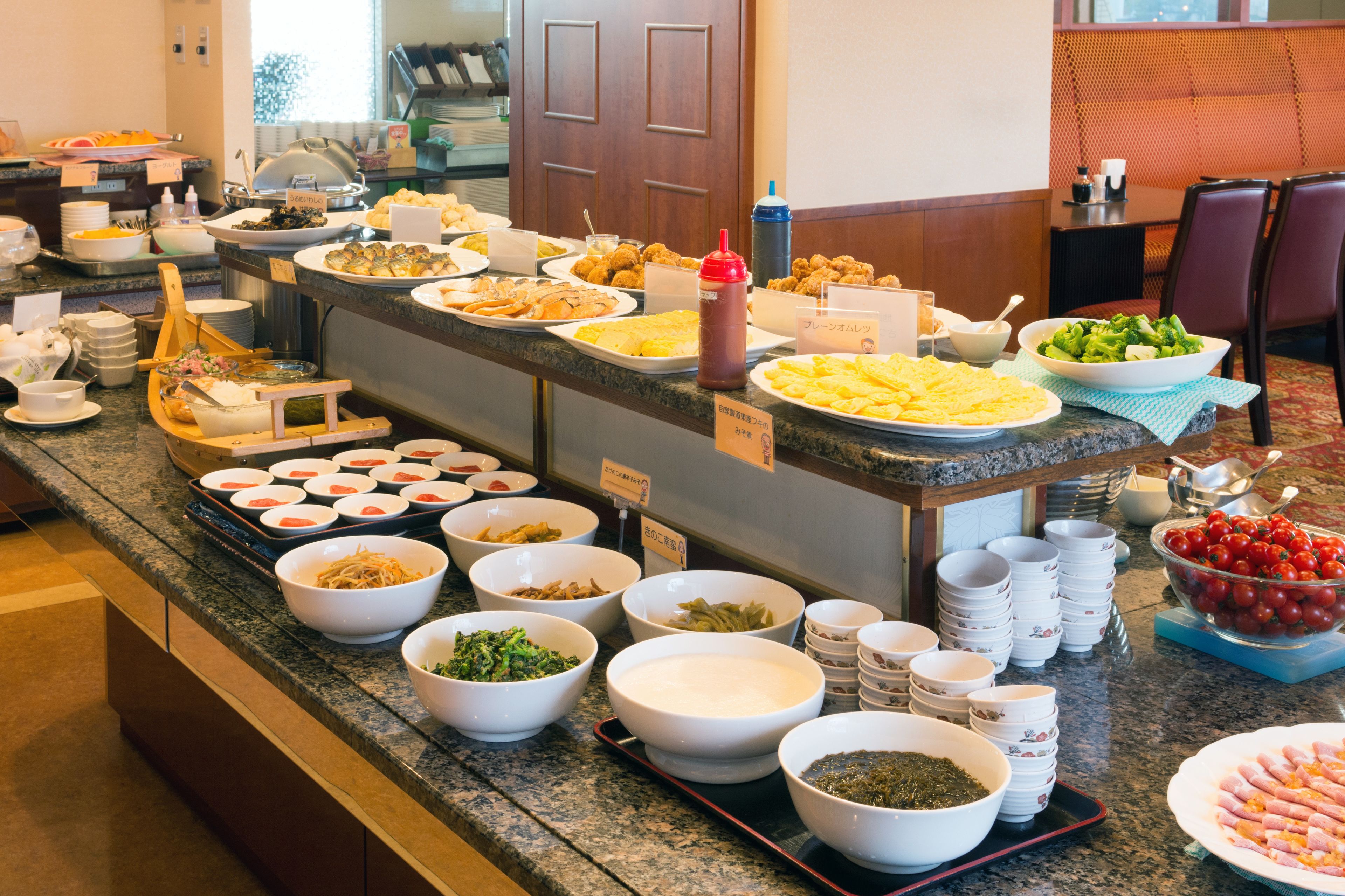 A buffet with various dishes and beverages.
