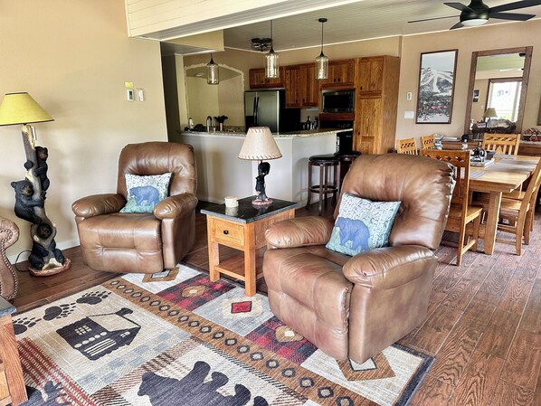 A living room with leather chairs, a coffee table, and a patterned rug. - Stay just steps from the Gondola! (Steamboat Springs)