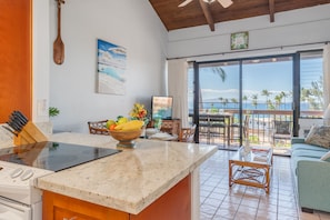 Enjoy ocean views from the dining area and living space, featuring a central kitchen island with induction cooktop.