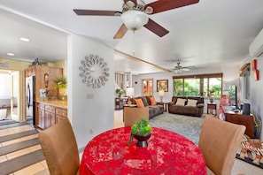 Relax in this well-appointed living area with a central table, comfortable sofas, and a decorative wall piece.