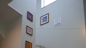 A staircase with wooden handrails and a light-colored wall. - Bliss & Bless Furano (Furano)