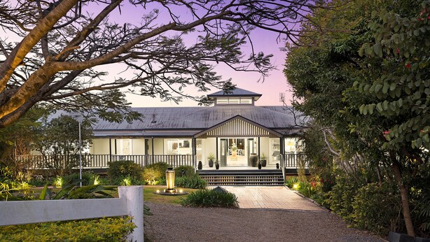 A house with a covered porch, a gravel driveway, and a well-maintained garden. - The Country House at Hunchy Montville (Hunchy)