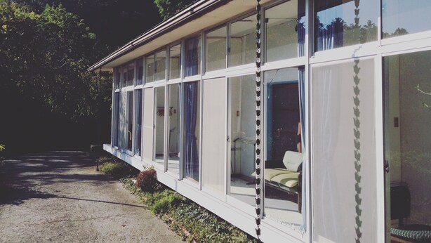 A modern building with large windows and a balcony. - Amanohashidate Youth Hostel (Miyazu)