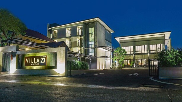 A modern villa with a gated entrance, large windows, and a well-lit facade. - VILLA23 Residence (Bangkok)