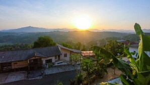 A residential area with a house featuring a tiled roof and a visible signboard. - Romance Hills Hotel (Kandy)