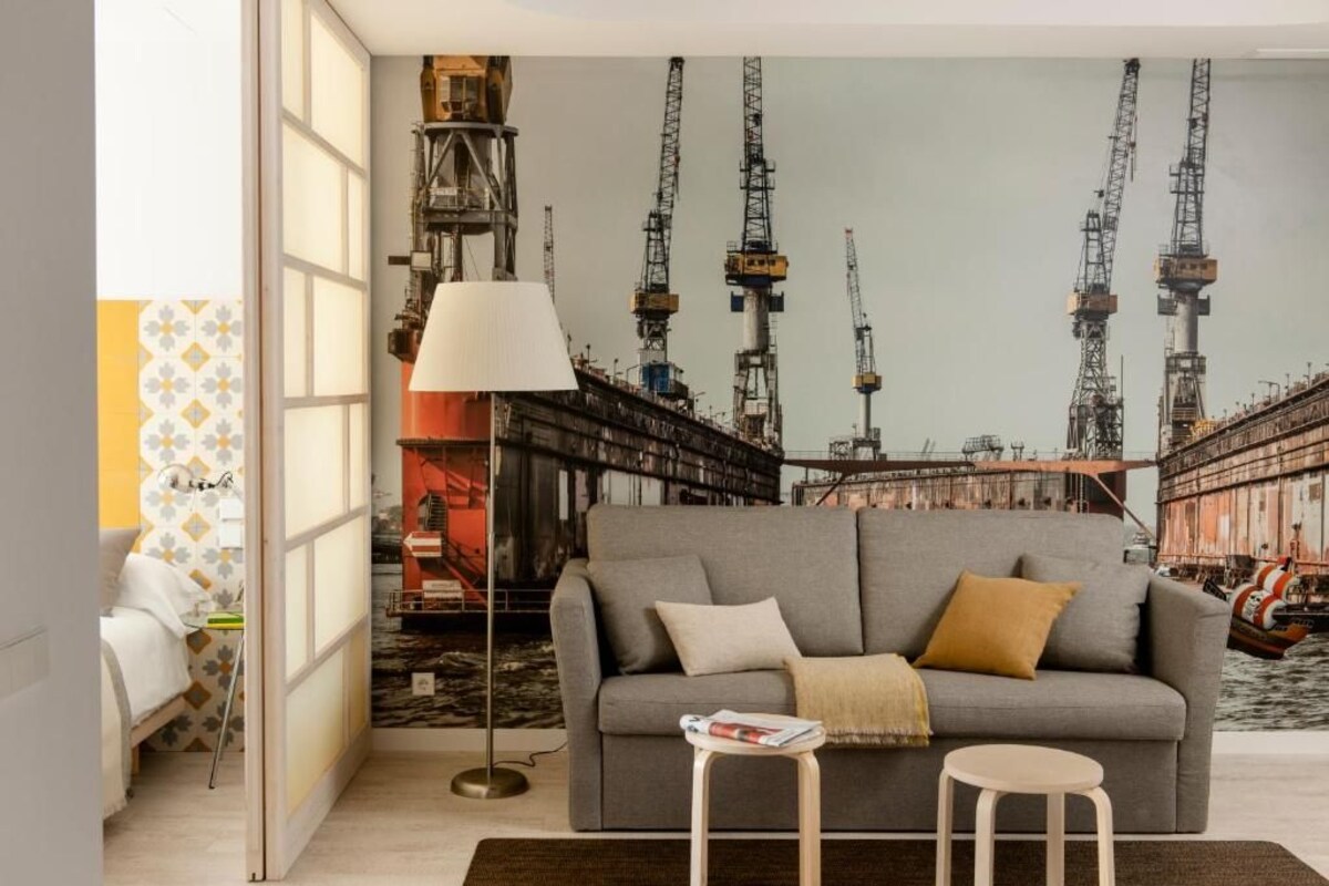 A living room with a grey sofa, a small round table, and a floor lamp.