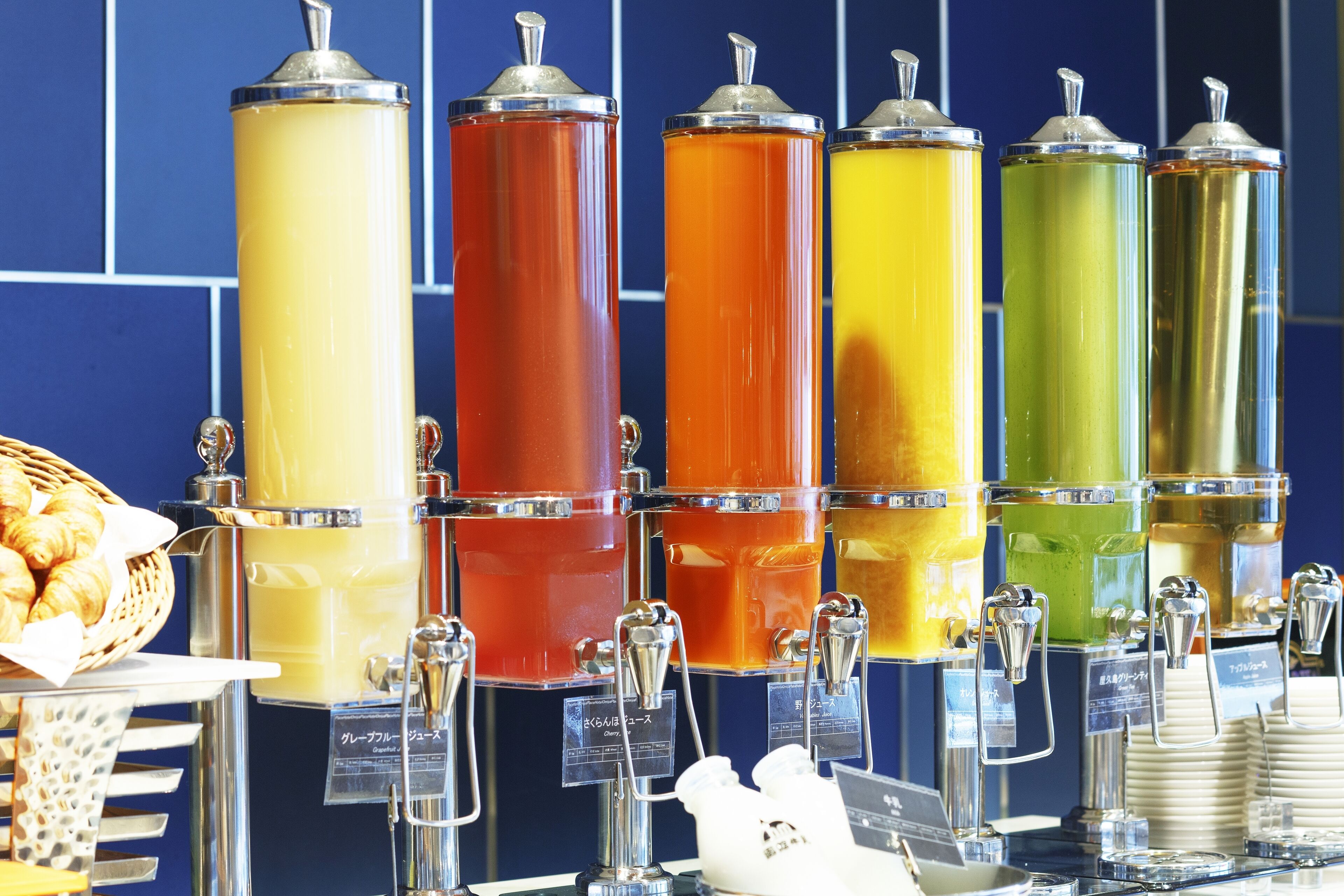 A beverage station with multiple dispensers in different colors.