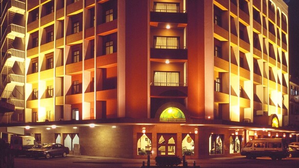 A multi-story hotel with a central entrance and balconies on each floor. - Royal Court Hotel (Mombasa)