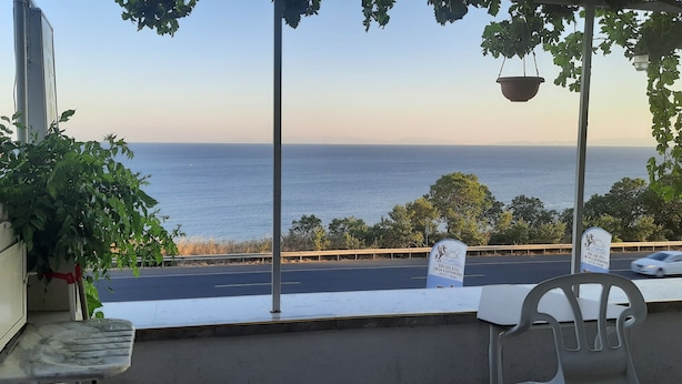 A view from a balcony overlooking a road with a sign for "Dallas O'Neil Hotel." - Dallas Hotel (Marmara Ereglisi)