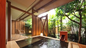 A hot spring area with wooden benches and a small wooden structure. - Kagetsutei (Shimoda)