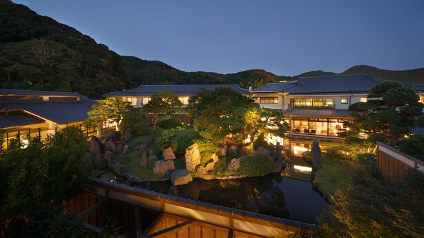 A traditional Japanese-style building complex with multiple structures, a koi pond, and surrounding greenery. - Kagetsutei (Shimoda)