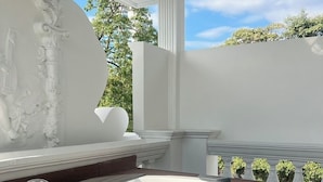 A modern outdoor hot tub with a built-in sink and faucet, surrounded by a wooden deck and white walls.