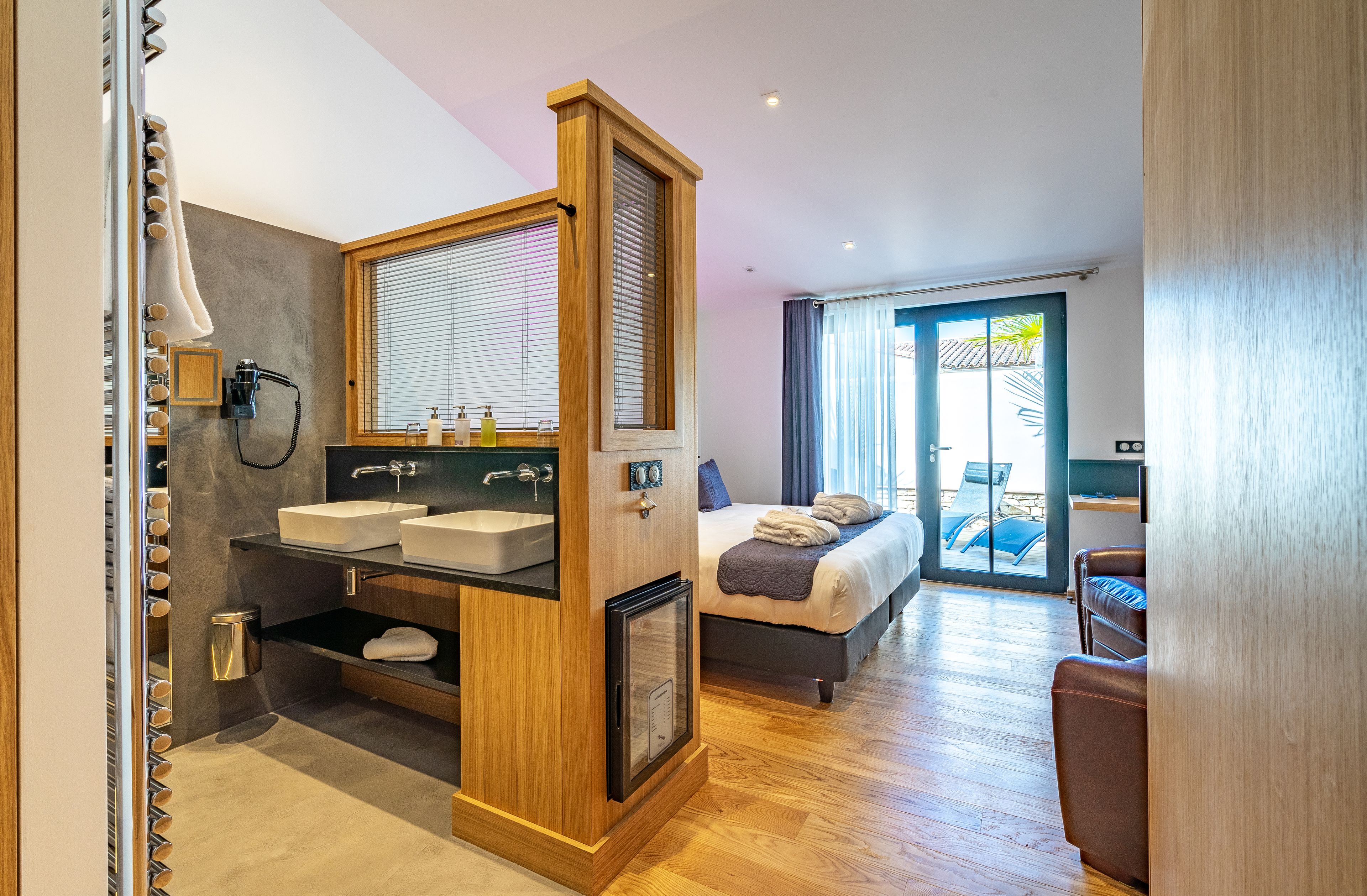 A modern bathroom with a vanity, double sink, and a mirror.