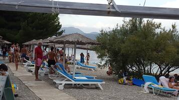 White sand, sun-loungers, beach umbrellas, beach bar