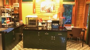 A kitchen with a central island, a coffee machine, a toaster, and a refrigerator. - Nung Ni Bangkonthi (Bang Khonthi)