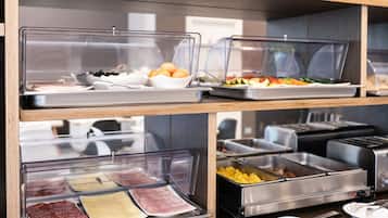 A buffet with various food items in clear containers, including meats, cheeses, and fruits.