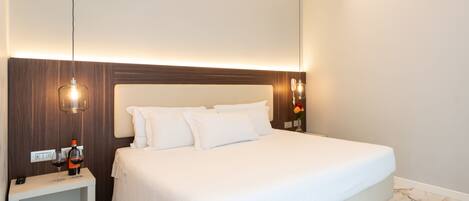 A modern hotel room with a large bed, marble flooring, a bedside table with a wine bottle, and a nightstand.