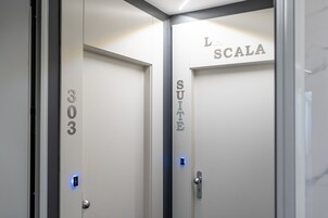 Two doors with room numbers and names: 303 and L. Scal Suite.