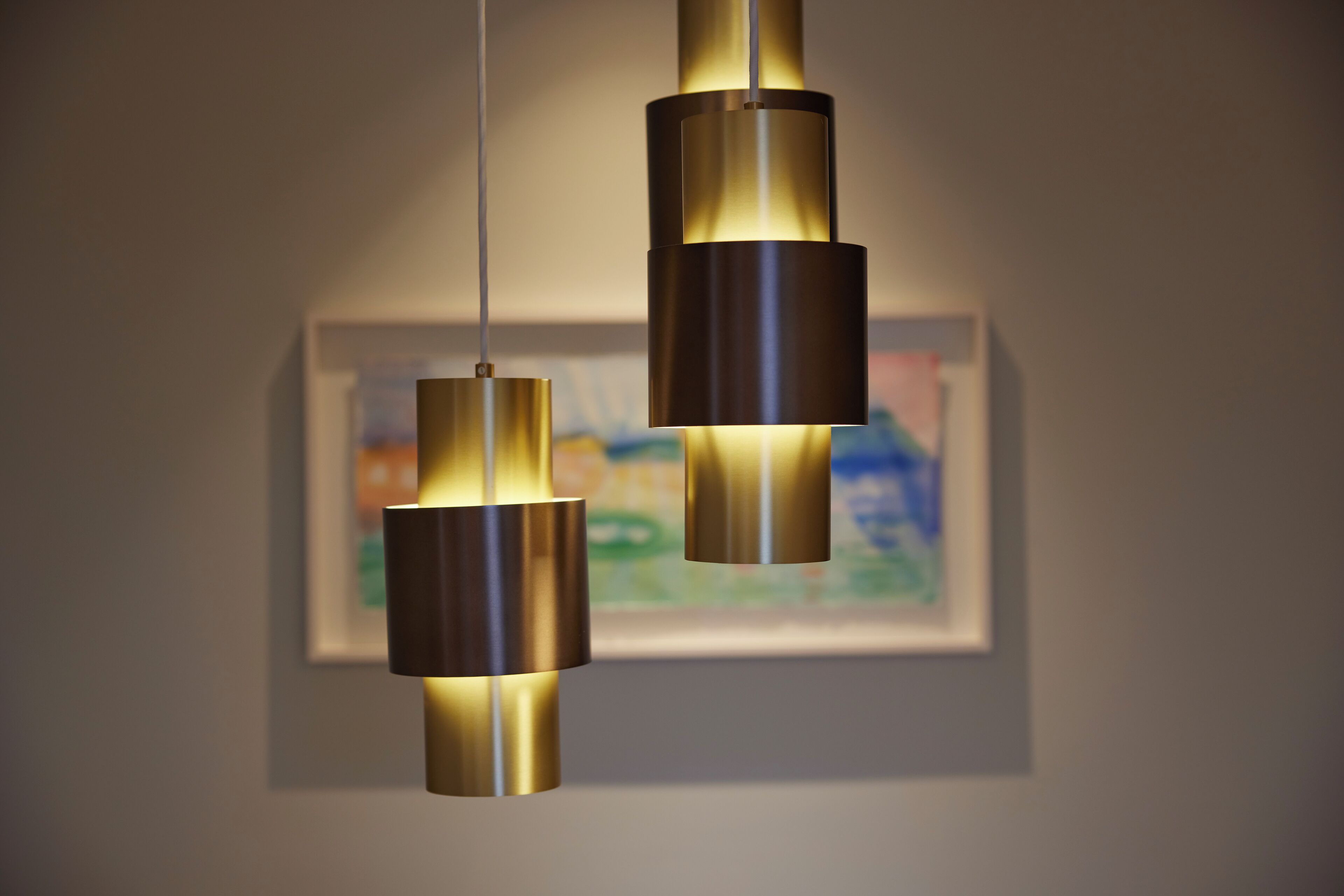 A modern pendant light fixture with a minimalist design, hanging from the ceiling.