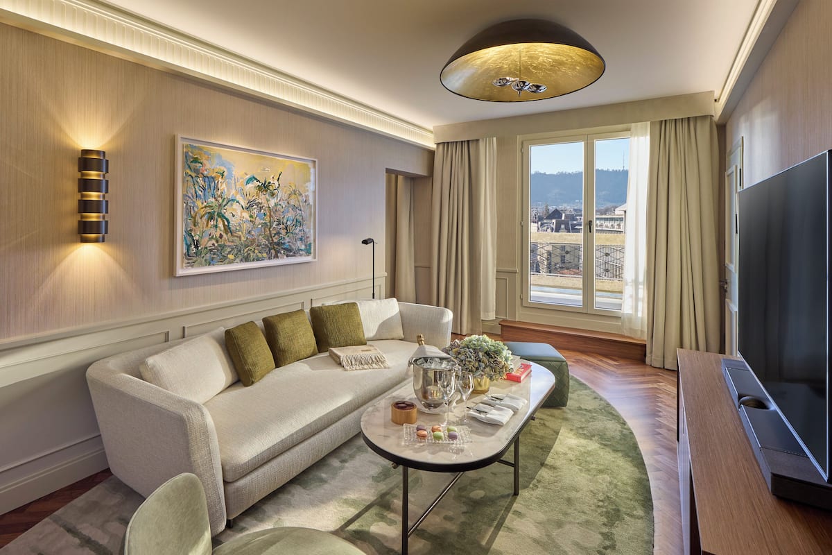 A modern living room with a sofa, a coffee table, and a television.