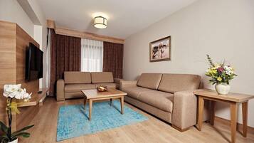 A modern living room with a sofa, coffee table, and TV.