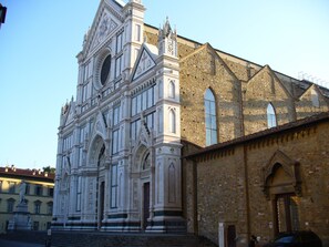 A historic building with ornate architectural details, including a large central window and multiple arched doorways. - Residenza San Lorenzo (Florence)