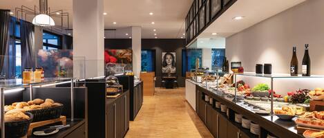 A modern breakfast bar with a variety of food options and a large window in the background.