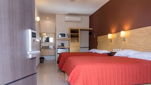 A hotel room with two beds, a microwave, a small kitchenette, and a wardrobe. - Nova Hotel (Cadereyta Jimenez)