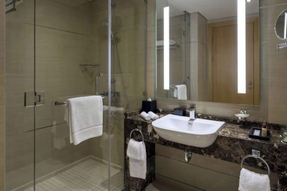 Bathroom | Designer toiletries, hair dryer, slippers, towels