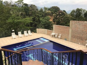 A swimming pool with a view of a mountainous landscape.