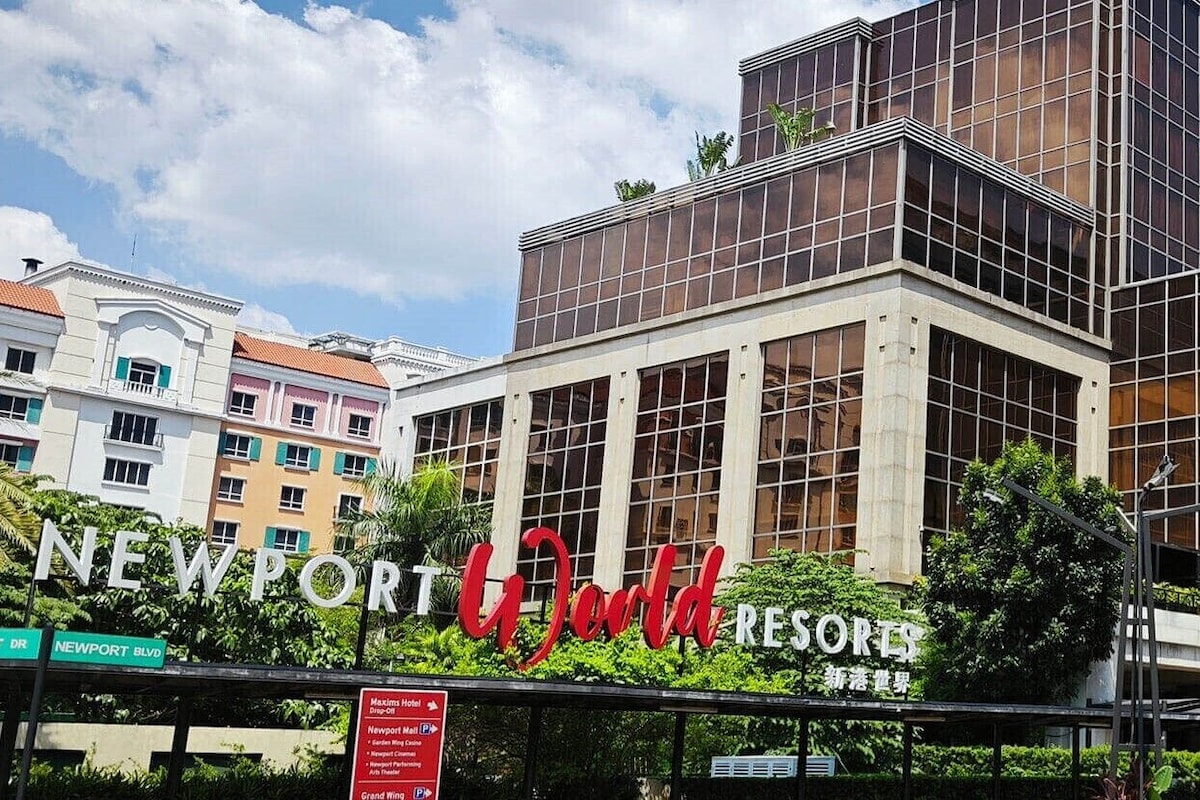 A modern hotel with a prominent sign reading "NEWPORT WORLD RESORTS".