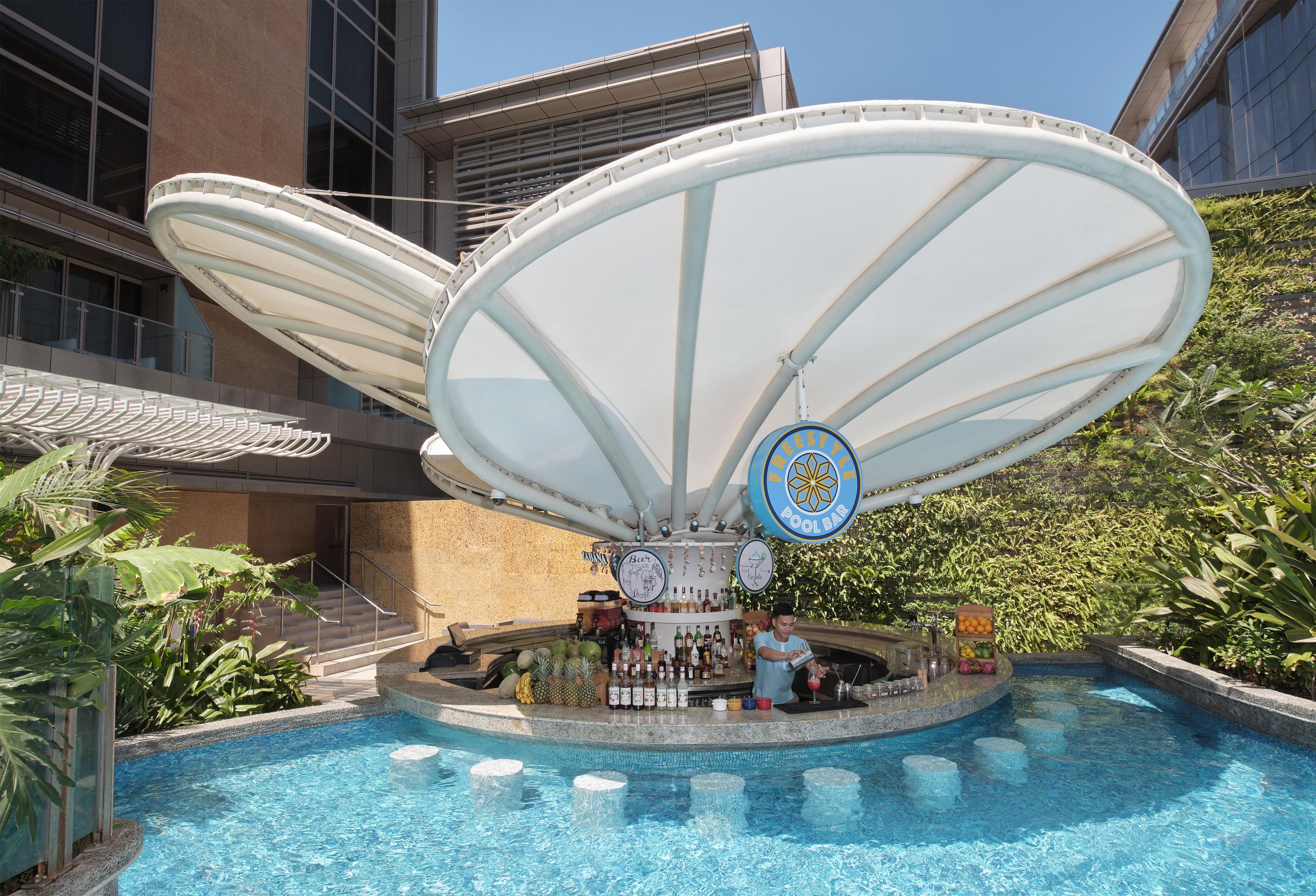 A pool area with a bar and a large umbrella structure.