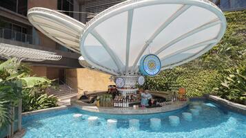 A pool area with a bar and a large umbrella structure.