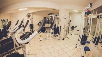 A gym with various exercise equipment, including treadmills and weight machines.