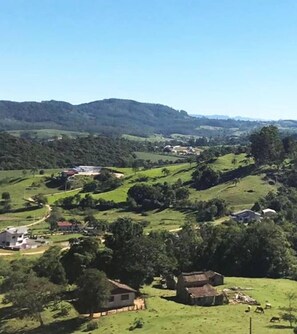A rural landscape with rolling hills, scattered houses, and a clear sky. - Real Nob Hotel (Orleans)