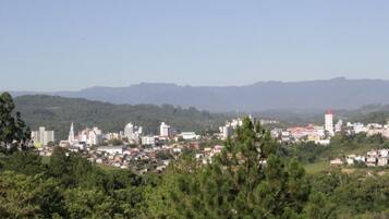 A cityscape with buildings, a prominent church, and mountains in the background.