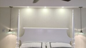 A bedroom with a white four-poster bed, a ceiling fan, and recessed lighting. - La Porta Della Casa (Prospect)