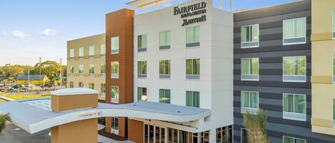 A multi-story hotel with a modern design, featuring a prominent sign for Fairfield Inn & Suites by Marriott.