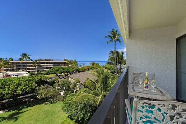 Private lanai view with lush grounds, palms, and peaceful Maui scenery.