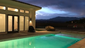 Una piscina con vistas a montañas al fondo.