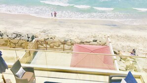 A beach view with a wooden fence and a red-roofed structure. - 5 BR Large Beach House, Beachfront with Fire Ring,  Walk to Restaurants (Oceanside)