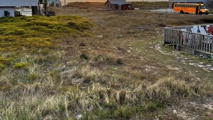 A rural landscape with houses, a bus, and a path. - OBX, NC, Pristine Ocean Views without oceanfront price! (Kitty Hawk)