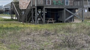 A multi-story wooden building with balconies and a staircase leading to the ground level. - OBX, NC, Pristine Ocean Views without oceanfront price! (Kitty Hawk)