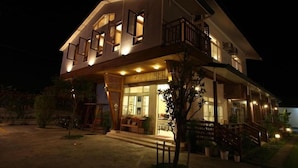 A two-story house with a balcony, a porch, and a staircase leading to the upper floor. - Country View B&B (Ji'an)