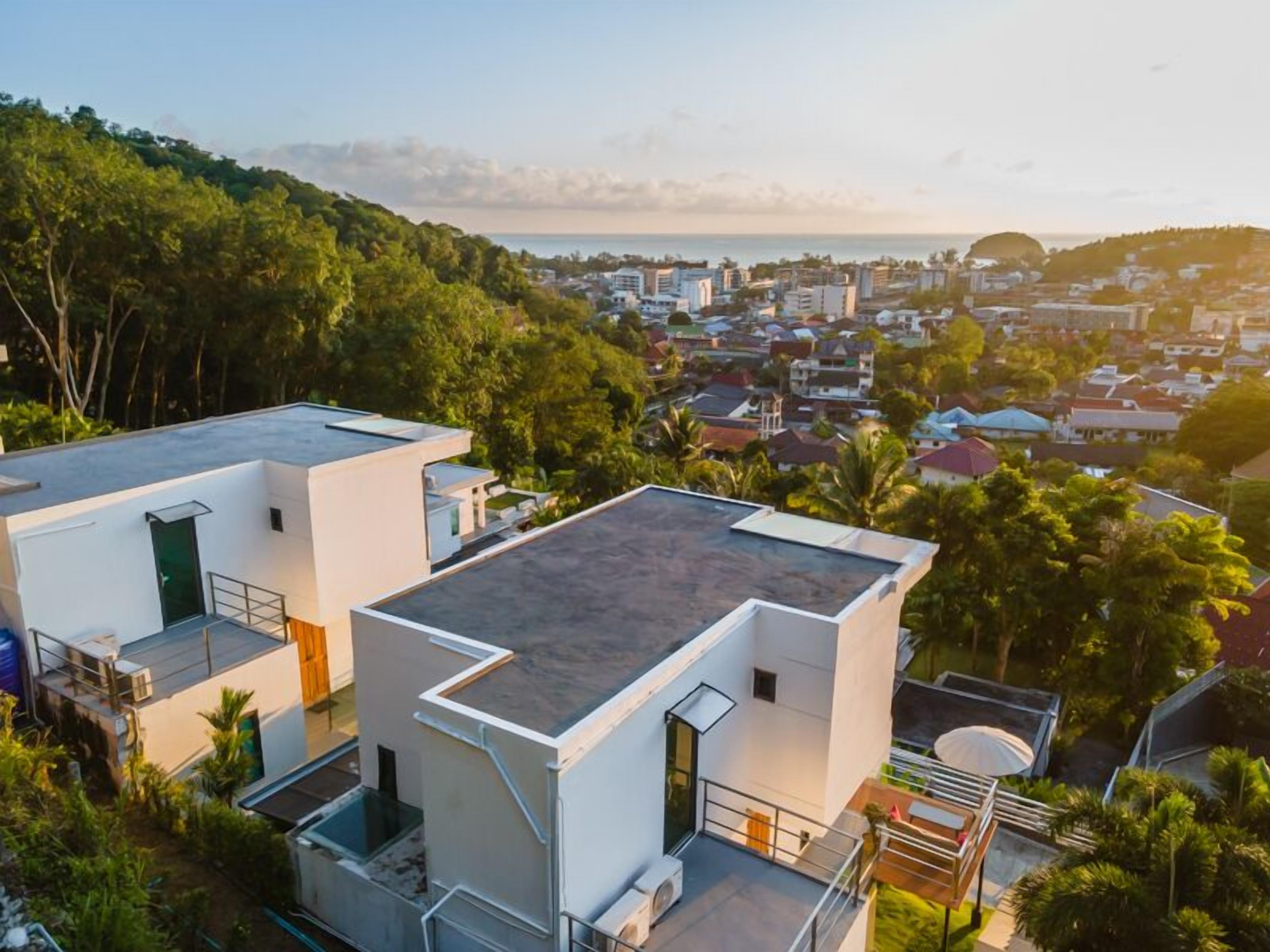 A modern residential area with compact houses featuring flat roofs and minimalistic design.