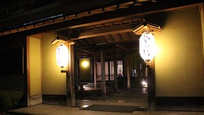 A traditional Japanese building entrance at night with two illuminated lanterns. - Matsuriya Yuzaemon (Fukushima)